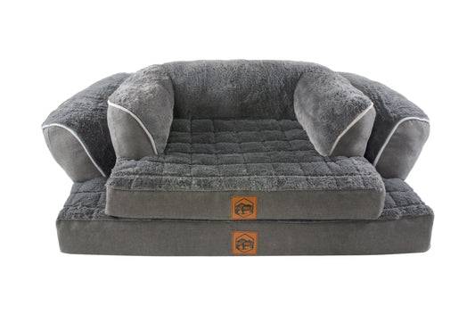 A gray sofa bed with an orthopaedic base, plush cushions and a waterproof base, designed for pet relaxation.
