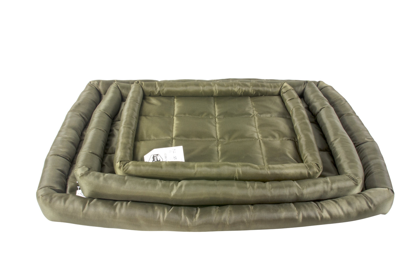 A waterproof dog crate bed in green color, displayed in a stack of different sizes. The Fat Mile tag attached.