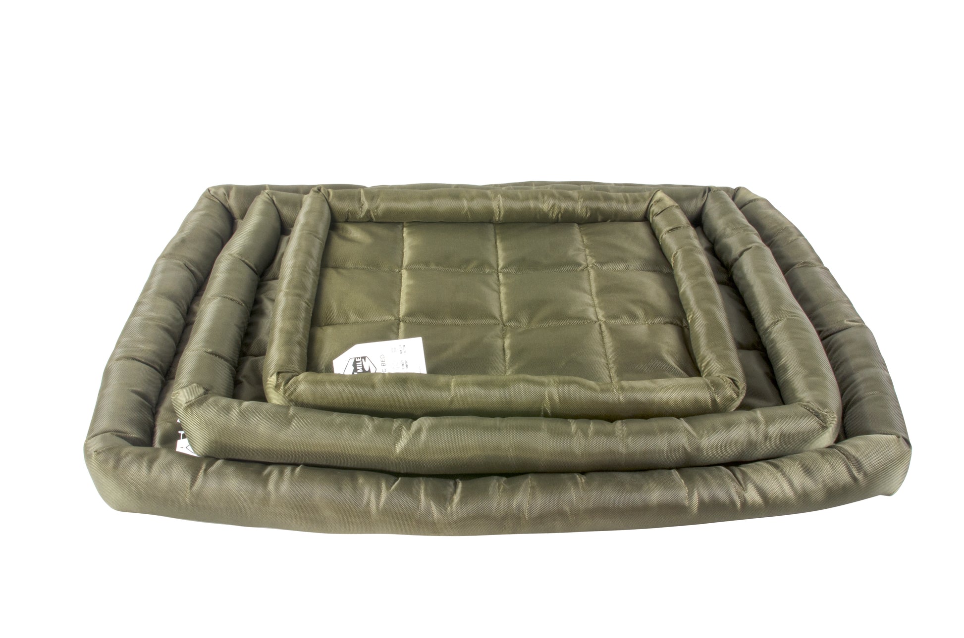 A waterproof dog crate bed in green color, displayed in a stack of different sizes. The Fat Mile tag attached.