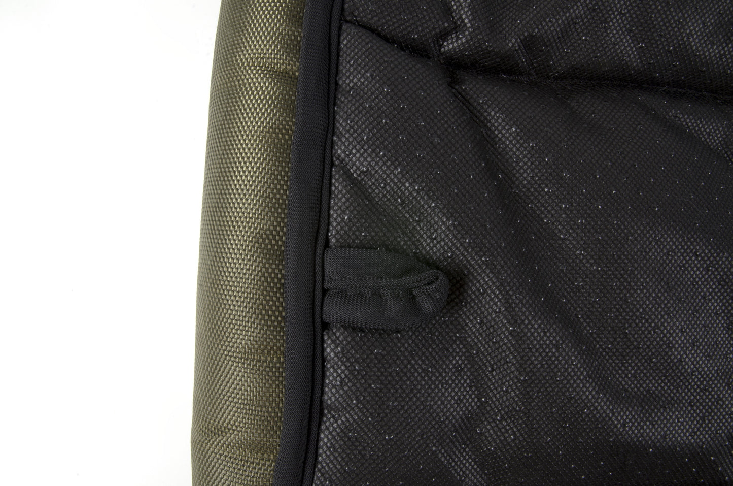 A waterproof dog crate bed in green color. The Fat Mile tag attached.