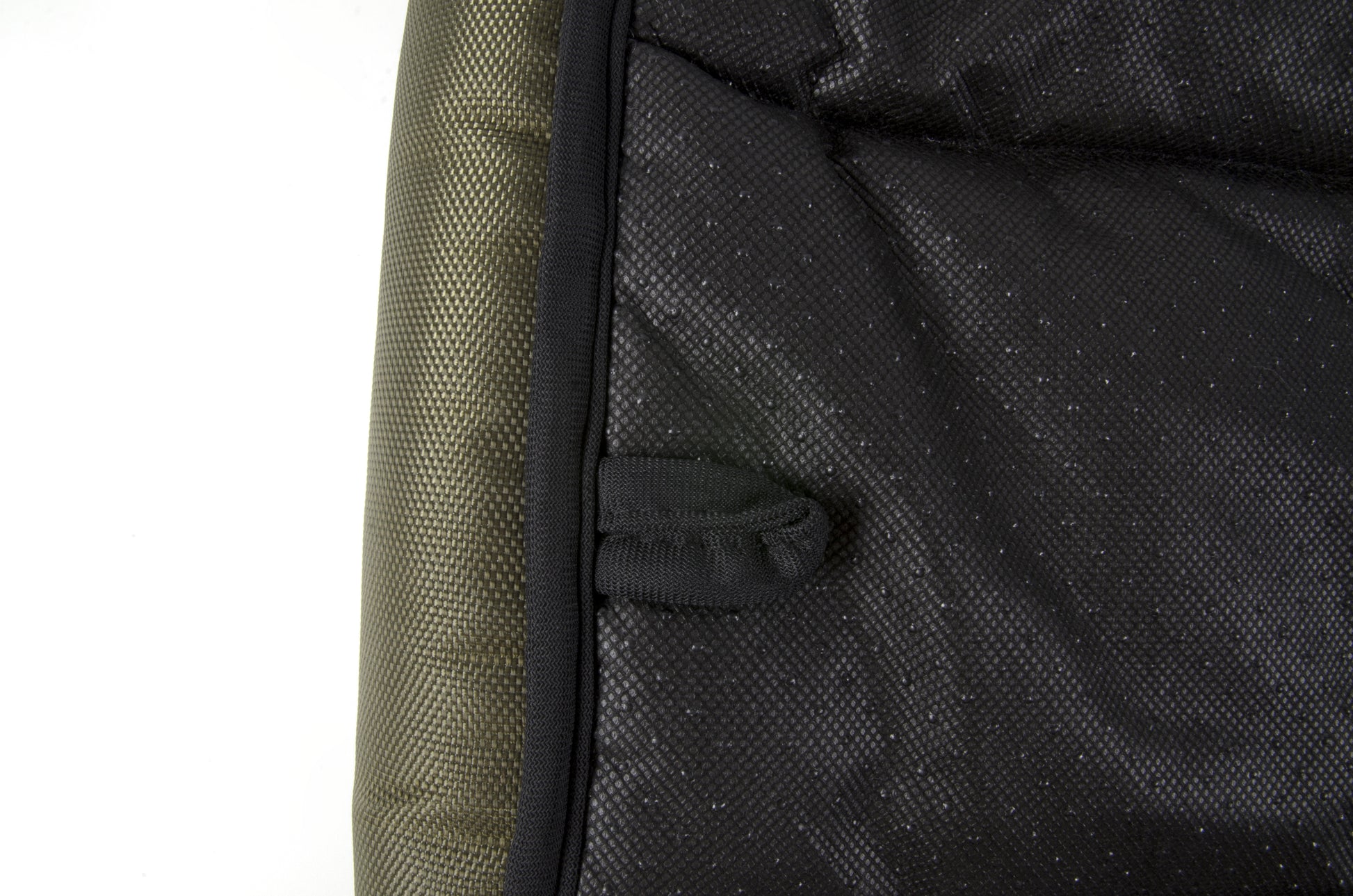 A waterproof dog crate bed in green color. The Fat Mile tag attached.