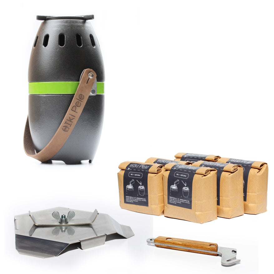 A black portable ikipele wood pellet patio heater with a brown carrying strap, alongside packages of wood pellets and a metal stove accessory with a wooden handle.