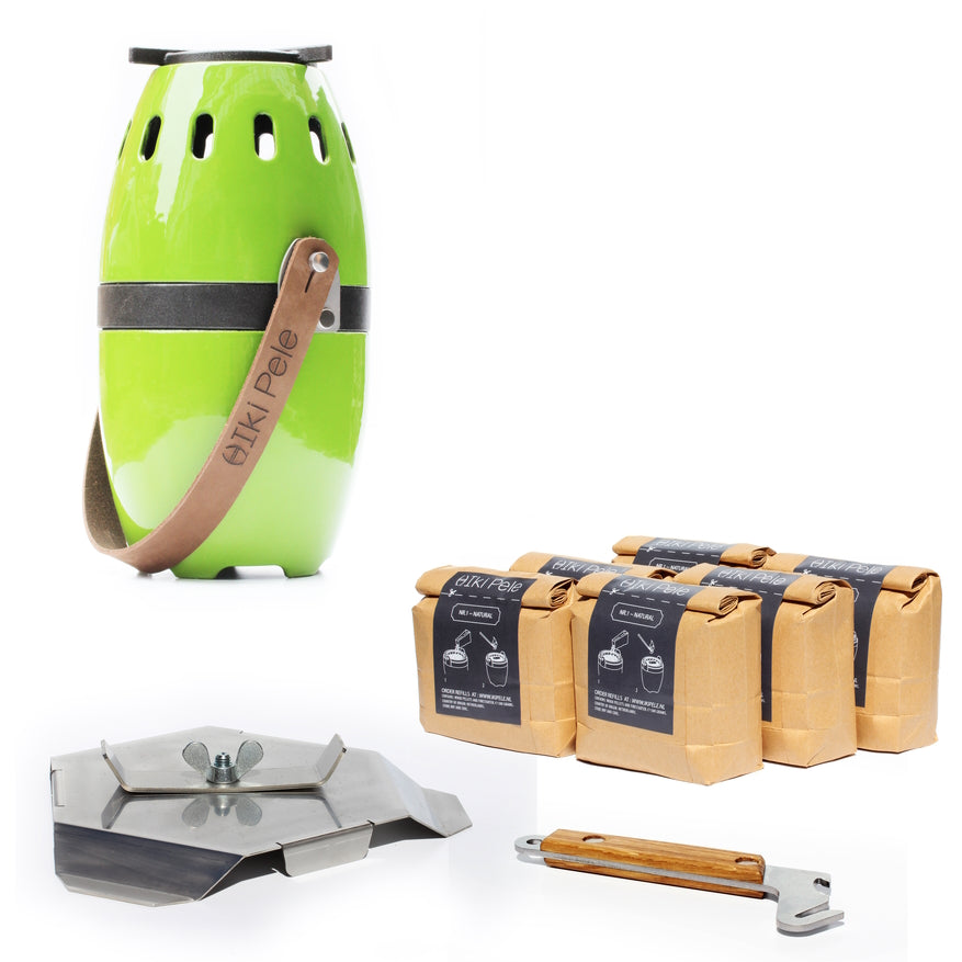 A green portable ikipele wood pellet patio heater with a brown carrying strap, alongside packages of wood pellets and a metal stove accessory with a wooden handle.