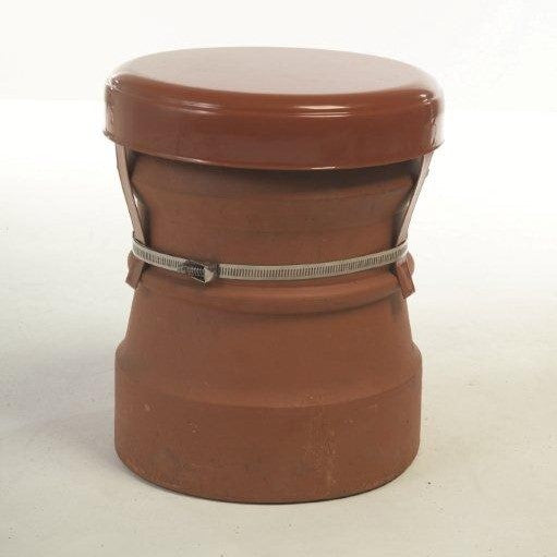 A terracotta metal chimney cowl with a lid and a strap used for capping off unused chimneys.