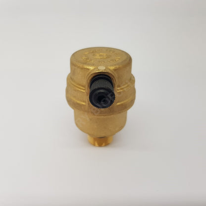 A gold-coloured pressure relief valve, with a black relief knob in front.