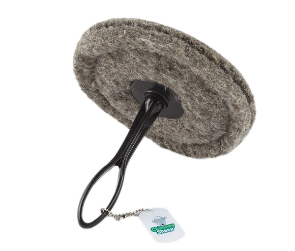 A gray 8" round chimney sheep with a handle and extension rod, laying sideways.