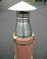 An 8 to 4 silver reducing cowl on a ceramic chimney pot.