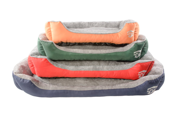 A stack of oxford dog beds in various colors including orange, red, green, and blue. Come in various sizes. The Fat Mile logo.