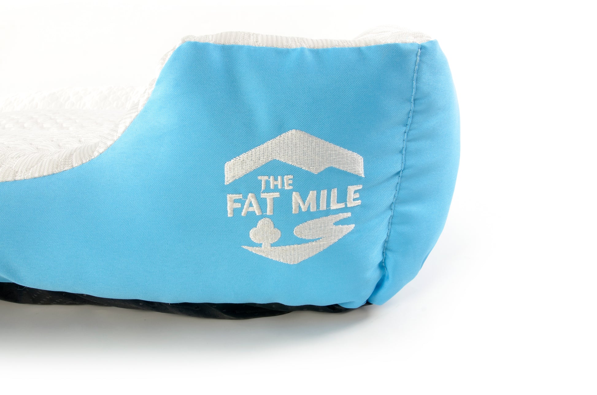 A set of cooling dog beds in blue and white colours, designed with a deep sleeping contour. Cool to the touch. A The Fat Mile logo on the right side.