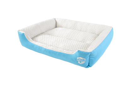 A set of cooling dog beds in blue and white colours, designed with a deep sleeping contour. Cool to the touch. A The Fat Mile logo on the right side.